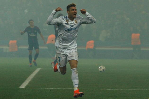 Real Madrid's Portuguese forward Cristiano Ronaldo celebrates after scoring the opening goal  during the UEFA Champions League round of 16 second leg football match between Paris Saint-Germain (PSG) and Real Madrid on March 6, 2018, at the Parc des Princes stadium in Paris. / AFP PHOTO / GEOFFROY VAN DER HASSELT        (Photo credit should read GEOFFROY VAN DER HASSELT/AFP/Getty Images)