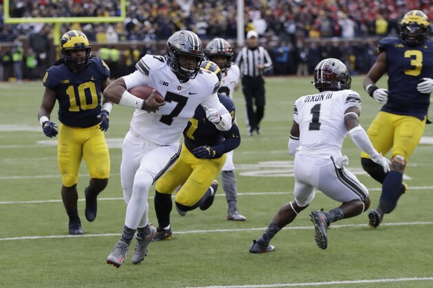 Ohio State quarterback Dwayne Haskins (7) scrambles to the one-yard line during the second half of an NCAA college football game against Michigan, Saturday, Nov. 25, 2017, in Ann Arbor, Mich. (AP Photo/Duane Burleson)