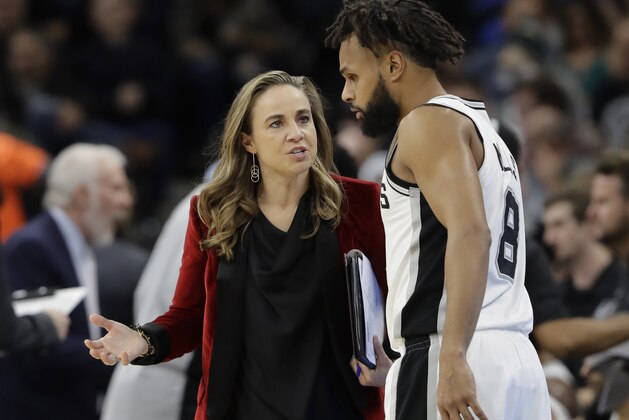 San Antonio Spurs assistant coach Becky Hammon, left, talks with guard Patty Mills (8) during the second half of an NBA basketball game against the New York Nets, Tuesday, Dec. 26, 2017, in San Antonio. San Antonio won 109-97.(AP Photo/Eric Gay)