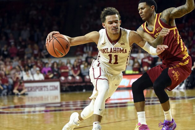 OKlahoma's Trae Young, left, drives past Iowa State's Donovan Jackson, right, in the second half of an NCAA college basketball game Friday, March 2, 2018, in Norman, Okla. (AP Photo/Kyle Phillips)