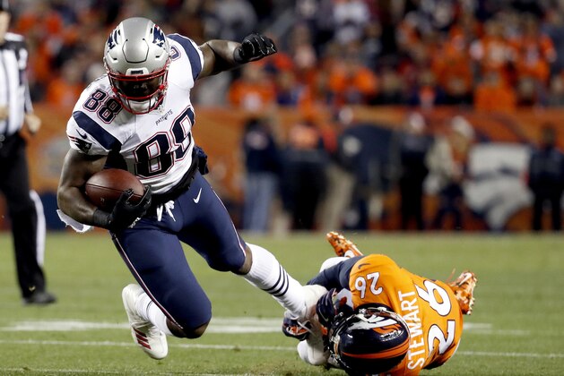 FILE - In this Sunday, Nov. 12, 2017, file photo, New England Patriots tight end Martellus Bennett (88) is tripped up by Denver Broncos free safety Darian Stewart (26) during the first half of an NFL football game in Denver. Bennett is still coming to terms with how his Green Bay tenure ended. But he says being back in familiar surroundings is helping him to deal with it. (AP Photo/Jack Dempsey, File)