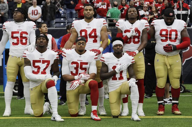 FILE - In this Dec. 10, 2017, file photo, San Francisco 49ers San Francisco 49ers' Eli Harold (57), Eric Reid (35) and Marquise Goodwin (11) kneel during the national anthem before an NFL football game against the Houston Texans, in Houston. President Donald Trump's feud with the NFL about players kneeling during the national anthem is the runaway winner for the top sports story of 2017 in balloting by AP members and editors.  (AP Photo/David J. Phillip, File)