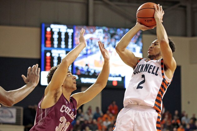 Bucknell's Stephen Brown (2) shoots over Colgate's Francisco Amiel during the second half of an NCAA college basketball game for the Patriot League men's tournament championship in Lewisburg, Pa., Wednesday, March 7, 2018. Bucknell won 83-54. (AP Photo/Chris Knight)