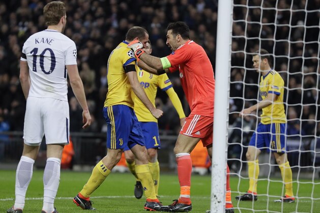Juventus goalkeeper Gianluigi Buffon congratulates his teammate Giorgio Chiellini during the Champions League, round of 16, second-leg soccer match between Juventus and Tottenham Hotspur, at the Wembley Stadium in London, Wednesday, March 7, 2018. (AP Photo/Kirsty Wigglesworth)