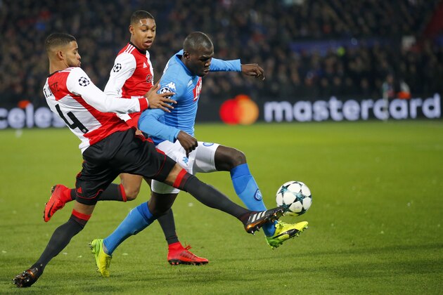 Napoli's Kalidou Koulibaly, right, challenges for the ball with Feyenoord's Jeremiah St. Juste, left, during a Champions League Group F soccer match between Feyenoord and Napoli at the Kuip stadium in Rotterdam, Netherlands, Wednesday, Dec. 6, 2017. (AP Photo/Peter Dejong)