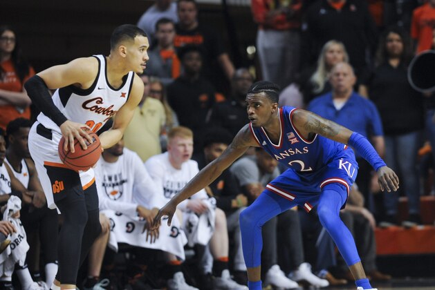 Kanasa forward Cameron McGriff defends against an advancing Oklahoma State forward Jeffrey Carroll during an NCAA college basketball game in Stillwater, Okla., Saturday, March. 3, 2018.(AP Photo/Brody Schmidt)