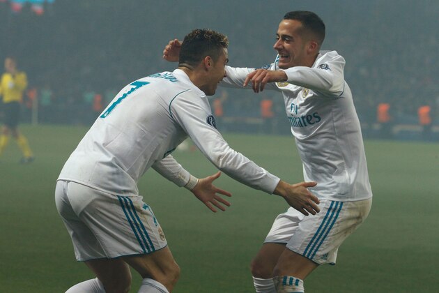 Real Madrid's Portuguese forward Cristiano Ronaldo (L) celebrates with Real Madrid's Spanish midfielder Lucas Vazquez after scoring the opening goal  during the UEFA Champions League round of 16 second leg football match between Paris Saint-Germain (PSG) and Real Madrid on March 6, 2018, at the Parc des Princes stadium in Paris. / AFP PHOTO / GEOFFROY VAN DER HASSELT        (Photo credit should read GEOFFROY VAN DER HASSELT/AFP/Getty Images)