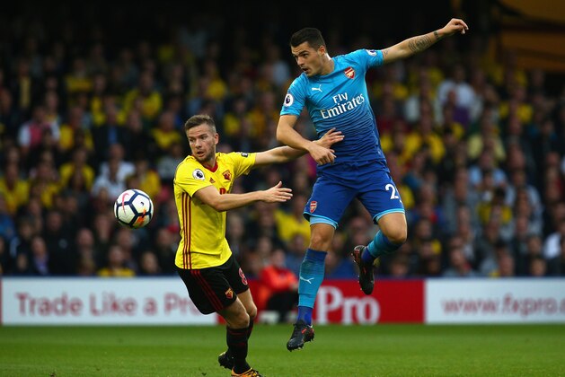WATFORD, ENGLAND - OCTOBER 14:  Tom Cleverley of Watford and Granit Xhaka of Arsenal in action during the Premier League match between Watford and Arsenal at Vicarage Road on October 14, 2017 in Watford, England.  (Photo by Charlie Crowhurst/Getty Images)
