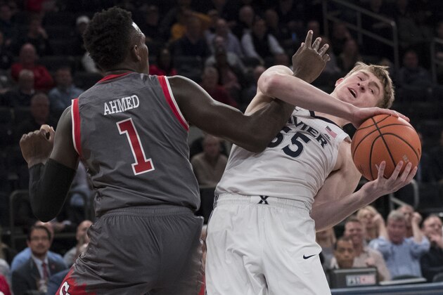 St. John's guard Bashir Ahmed (1) guards Xavier guard J.P. Macura (55) during the first half of an NCAA college basketball game in the quarterfinals of the Big East conference tournament, Thursday, March 8, 2018, at Madison Square Garden in New York. (AP Photo/Mary Altaffer)