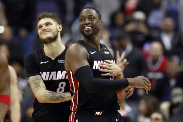 Miami Heat guard Tyler Johnson, left, reacts with guard Dwyane Wade during the overtime period an NBA basketball game against the Washington Wizards, Tuesday, March 6, 2018, in Washington. The Wizards won 117-113. (AP Photo/Alex Brandon)