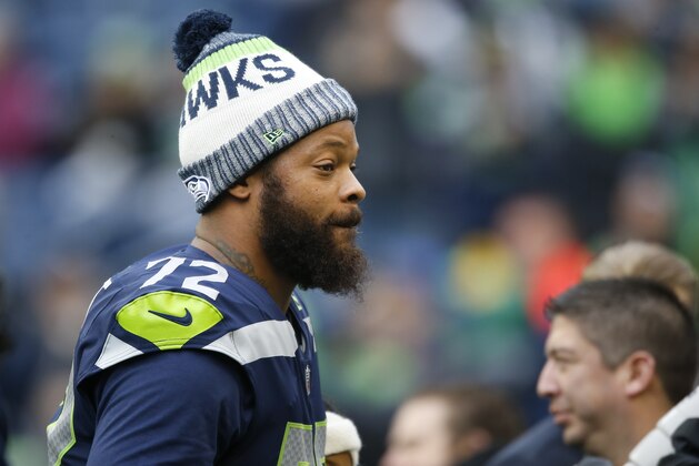 SEATTLE, WA - DECEMBER 17:  Defensive end Michael Bennett #72 of the Seattle Seahawks walks the field before the game against the Los Angeles Rams at CenturyLink Field on December 17, 2017 in Seattle, Washington.  (Photo by Otto Greule Jr /Getty Images)