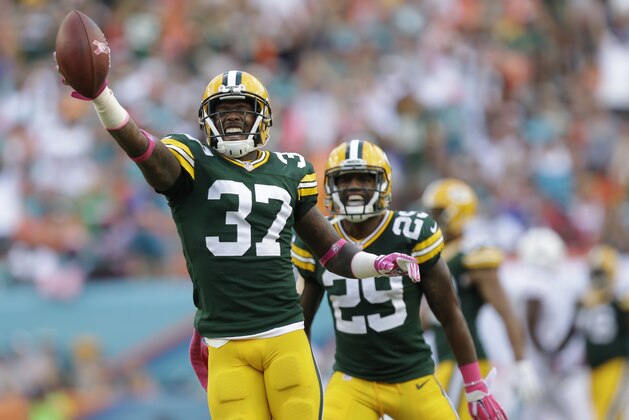 Green Bay Packers cornerback Sam Shields (37) holds the ball after intercepting a pass intended for Miami Dolphins wide receiver Brian Hartline (82) during the first half of an NFL football game, Sunday, Oct. 12, 2014, in Miami Gardens, Fla. In the background is Green Bay Packers cornerback Casey Hayward (29). AP Photo/Wilfredo Lee)