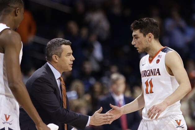 Virginia head coach Tony Bennett talks to Ty Jerome (11) during the first half of an NCAA college basketball game against Louisville in the quarterfinal round of the Atlantic Coast Conference tournament Thursday, March 8, 2018, in New York. (AP Photo/Frank Franklin II)