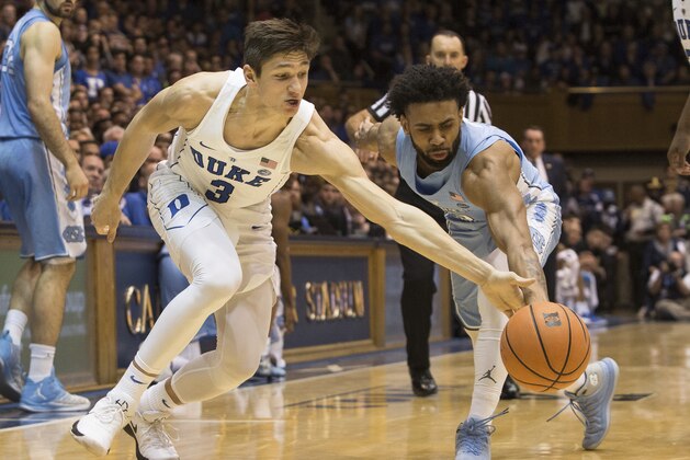 Duke's Grayson Allen (3) and North Carolina's Joel Berry II, right, reach for a loose ball during the first half of an NCAA college basketball game in Durham, N.C., Saturday, March 3, 2018. Duke defeated North Carolina 74-64. (AP Photo/Ben McKeown)