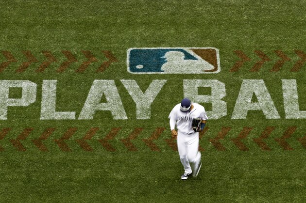 San Diego Padres left fielder Allen Cordoba passes a logo for Play Ball, an initiative from Major League Baseball and USA Baseball, during the fifth inning of a baseball game against the Colorado Rockies Saturday, June 3, 2017, in San Diego. (AP Photo/Gregory Bull)