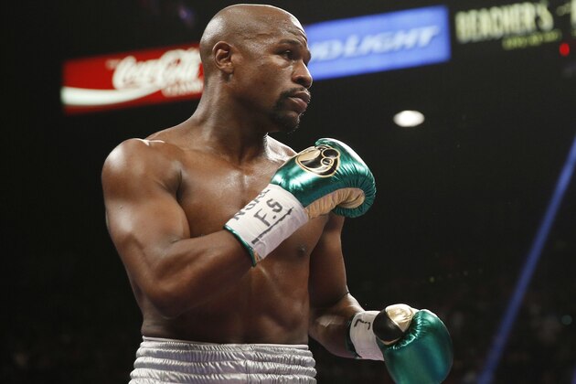 FILE - In this Sept. 12, 2015, file photo, Floyd Mayweather Jr. fights Andre Berto (not shown) during their welterweight title in Las Vegas. It’s still early, but give Round 1 of the trash talk battle between Conor McGregor and Mayweather Jr. to the Irish MMA star. (AP Photo/Steve Marcus, File)