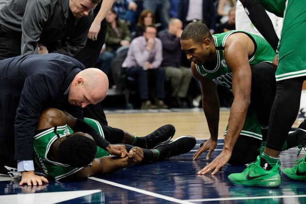 MINNEAPOLIS, MN - MARCH 08: Jaylen Brown #7 of the Boston Celtics is checked on by team officials and teammate Al Horford #42 after a hard fall during the fourth quarter of the game against the Minnesota Timberwolves on March 8, 2018 at the Target Center in Minneapolis, Minnesota. NOTE TO USER: User expressly acknowledges and agrees that, by downloading and or using this Photograph, user is consenting to the terms and conditions of the Getty Images License Agreement. (Photo by Hannah Foslien/Getty Images)