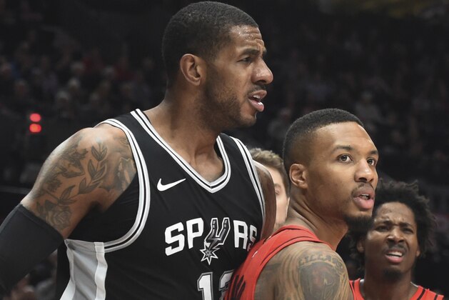 San Antonio Spurs forward LaMarcus Aldridge, left, reacts to a call, while standing next to Portland Trail Blazers guard Damian Lillard during the second half of an NBA basketball game in Portland, Ore., Wednesday, Dec. 20, 2017. The Spurs won 93-91. (AP Photo/Steve Dykes)