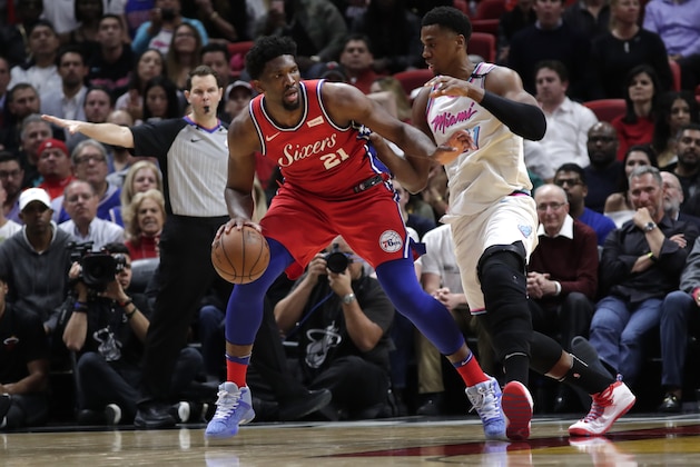Philadelphia 76ers' Joel Embiid, left drives past Miami Heat center Hassan Whiteside (21) during the second half of an NBA basketball game, Thursday, March 8, 2018, in Miami. The Heat won 108-99. (AP Photo/Lynne Sladky)