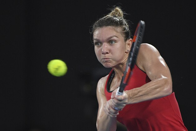 Romania's Simona Halep hits a backhand to Denmark's Caroline Wozniacki during the women's singles final at the Australian Open tennis championships in Melbourne, Australia, Saturday, Jan. 27, 2018. (AP Photo/Andy Brownbill)