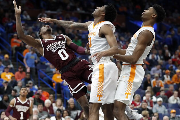 Mississippi State's Nick Weatherspoon (0) goes up for a layup past Tennessee's Jordan Bowden and Kyle Alexander, right, during the second half of an NCAA college basketball game in the quarterfinals of the Southeastern Conference tournament, Friday, March 9, 2018, in St. Louis. Weatherspoon was injured on the play and taken off on a stretcher. (AP Photo/Jeff Roberson)