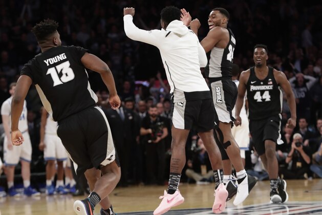 Providence's Kyron Cartwright (24) celebrates with teammates after overtime of an NCAA college basketball game against Xavier in the Big East men's tournament semifinals Friday, March 9, 2018, in New York. (AP Photo/Frank Franklin II)