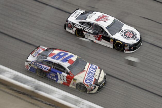 Monster Energy NASCAR Cup Series drivers Kyle Busch (18) and Kevin Harvick (4) races down the front stretch during the NASCAR Cup Series auto race at Atlanta Motor Speedway in Hampton, Ga., on Sunday, Feb. 25, 2018. (AP Photo/Paul Abell)