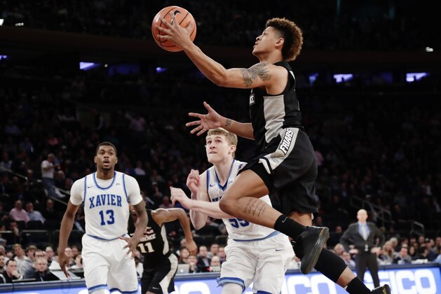 dProvidence's Makai Ashton-Langford (1) drives past Xavier's J.P. Macura (55) and Naji Marshall (13) during the second half of an NCAA college basketball game in the Big East men's tournament semifinals Friday, March 9, 2018, in New York. (AP Photo/Frank Franklin II)