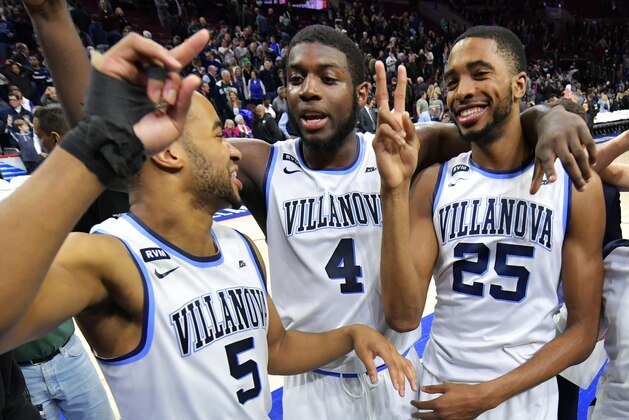 PHILADELPHIA, PA - MARCH 03: Phil Booth #5, Eric Paschall #4 and Mikal Bridges #25 of the Villanova Wildcats celebrate after the game against the Georgetown Hoyas at Wells Fargo Center on March 3, 2018 in Philadelphia, Pennsylvania. Villanova won 97-73. (Photo by Drew Hallowell/Getty Images)