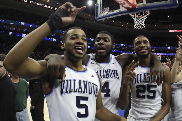 Villanova's Phil Booth, left, celebrates the win with Eric Paschall, center, and Mikal Bridges after the second half of an NCAA college basketball game against Georgetown, Saturday, March 3, 2018, in Philadelphia. Villanova won 97-73. (AP Photo/Chris Szagola)