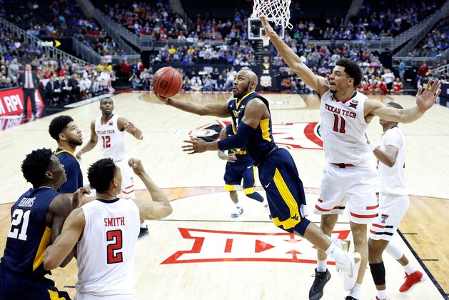 KANSAS CITY, MO - MARCH 09:  Jevon Carter #2 of the West Virginia Mountaineers drives toward the basket as Zach Smith #11 of the Texas Tech Red Raiders defends during the Big 12 Basketball Tournament semifinal game at Sprint Center on March 9, 2018 in Kansas City, Missouri.  (Photo by Jamie Squire/Getty Images)