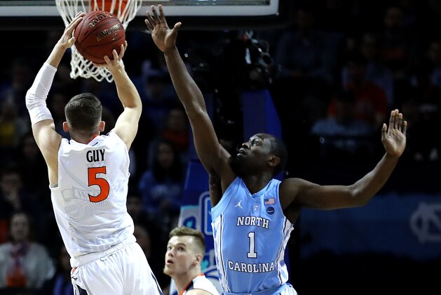 NEW YORK, NY - MARCH 10: Kyle Guy #5 of the Virginia Cavaliers takes a shot against Theo Pinson #1 of the North Carolina Tar Heels in the first half during the championship game of the 2018 ACC Men's Basketball Tournament at Barclays Center on March 10, 2018 in the Brooklyn borough of New York City.  (Photo by Abbie Parr/Getty Images)