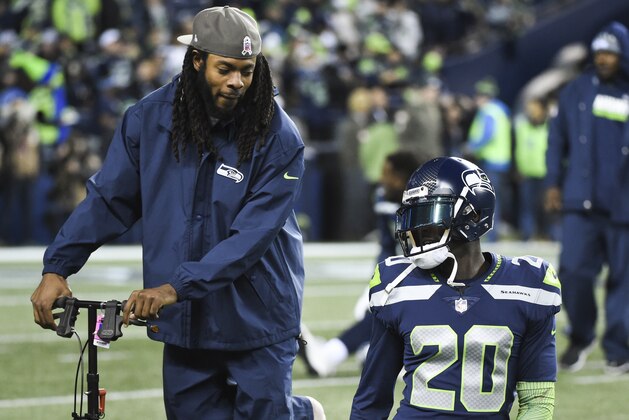 SEATTLE, WA - NOVEMBER 20: Cornerback Richard Sherman #25 of the Seattle Seahawks, out for the season with an Achilles injury, talks with cornerback Jeremy Lane #20 of the Seattle Seahawks before the game at CenturyLink Field on November 20, 2017 in Seattle, Washington.  (Photo by Steve Dykes/Getty Images)