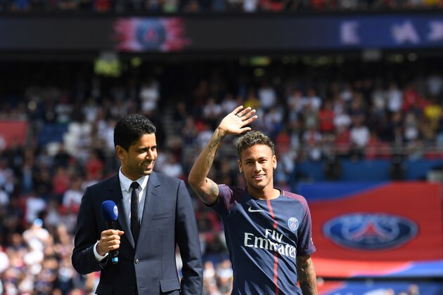 Paris Saint-Germain's Brazilian forward Neymar (C), flanked by Paris Saint Germain's (PSG) Qatari president Nasser Al-Khelaifi (L), waves to the crowd during his presentation to the fans at the Parc des Princes stadium in Paris, on August 5, 2017.
Brazil superstar Neymar will watch from the stands as Paris Saint-Germain open their season on August 5, 2017, but the French club have already clawed back around a million euros on their world record investment. Neymar, who signed from Barcelona for a mind-boggling 222 million euros ($264 million), is presented to the PSG support prior to his new team's first game of the Ligue 1 campaign against promoted Amiens.
 / AFP PHOTO / ALAIN JOCARD        (Photo credit should read ALAIN JOCARD/AFP/Getty Images)