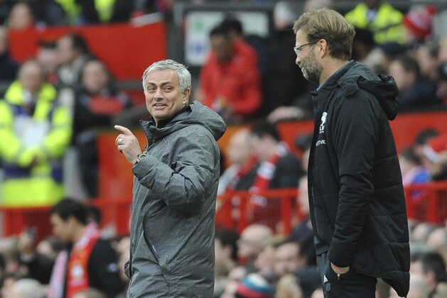 Manchester United coach Jose Mourinho, left, and Liverpool coach Juergen Klopp react on the sidelines during the English Premier League soccer match between Manchester United and Liverpool at Old Trafford in Manchester, England, Saturday, March 10, 2018. (AP Photo/Rui Vieira)
