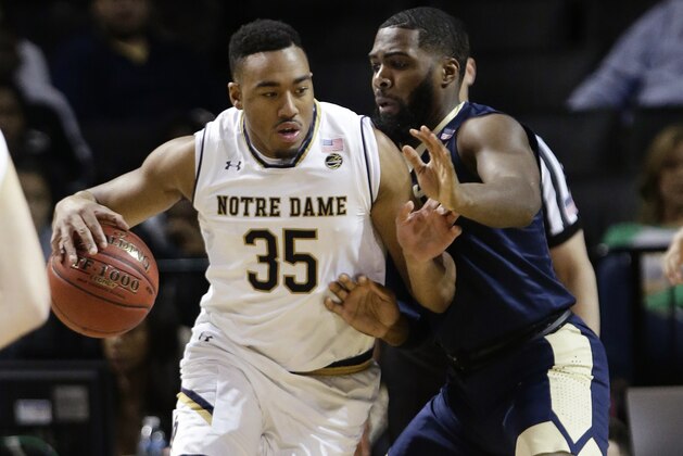 Pittsburgh's Jared Wilson-Frame (0) defends as Notre Dame's Bonzie Colson (35) works the ball during the first half of an NCAA college basketball game in the first round of the Atlantic Coast Conference tournament Tuesday, March 6, 2018, in New York. (AP Photo/Frank Franklin II)
