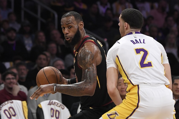 Cleveland Cavaliers forward LeBron James, left, tries to get past Los Angeles Lakers guard Lonzo Ball during the first half of an NBA basketball game, Sunday, March 11, 2018, in Los Angeles. (AP Photo/Mark J. Terrill)