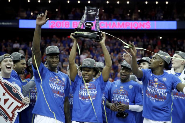 Kansas players celebrate after winning the NCAA college basketball championship game against West Virginia in the Big 12 men's tournament Saturday, March 10, 2018, in Kansas City, Mo. Kansas won 81-70. (AP Photo/Charlie Riedel)