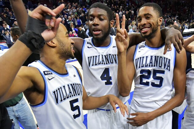 PHILADELPHIA, PA - MARCH 03: Phil Booth #5, Eric Paschall #4 and Mikal Bridges #25 of the Villanova Wildcats celebrate after the game against the Georgetown Hoyas at Wells Fargo Center on March 3, 2018 in Philadelphia, Pennsylvania. Villanova won 97-73. (Photo by Drew Hallowell/Getty Images)