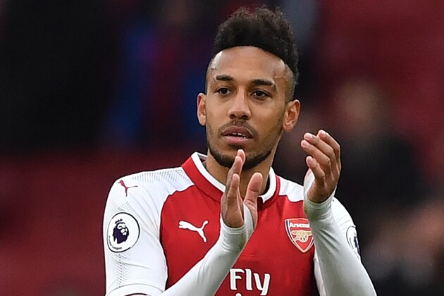 Arsenal's Gabonese striker Pierre-Emerick Aubameyang applauds supporters on the pitch after the English Premier League football match between Arsenal and Watford at the Emirates Stadium in London on March 11, 2018. 
Arsenal won the game 3-0. / AFP PHOTO / Ben STANSALL / RESTRICTED TO EDITORIAL USE. No use with unauthorized audio, video, data, fixture lists, club/league logos or 'live' services. Online in-match use limited to 75 images, no video emulation. No use in betting, games or single club/league/player publications.  /         (Photo credit should read BEN STANSALL/AFP/Getty Images)