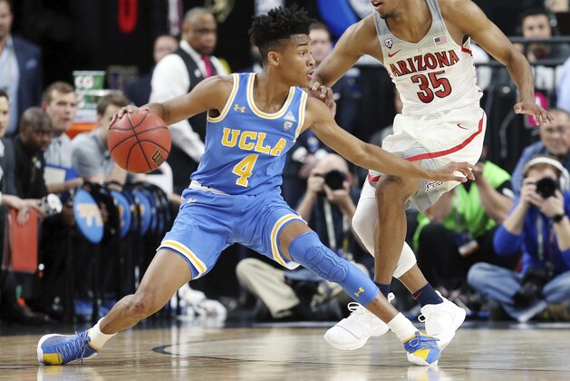 Arizona's Allonzo Trier (35) defends against UCLA's Jaylen Hands during the second half of an NCAA college basketball game in the semifinals of the Pac-12 men's tournament Friday, March 9, 2018, in Las Vegas. Arizona won 78-67 in overtime. (AP Photo/Isaac Brekken)