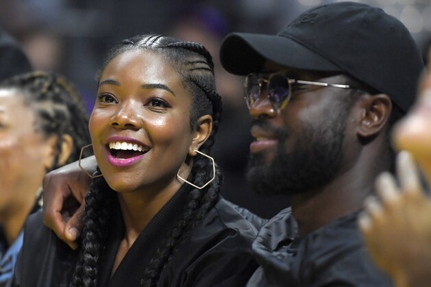 Chicago Bulls Dwyane Wade, right, watches with actress Gabrielle Union during the first half of a WNBA basketball game between the Los Angeles Sparks and the Atlanta Dream, Friday, Sept. 1, 2017, in Los Angeles. (AP Photo/Mark J. Terrill)