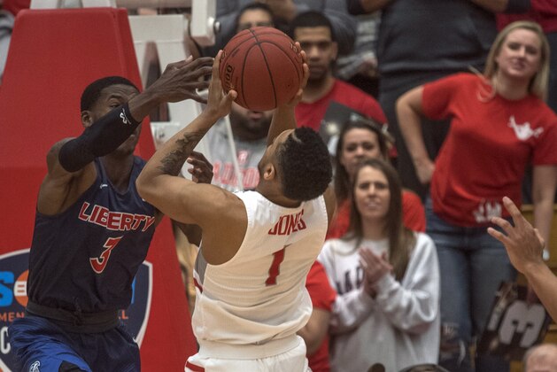 Radford guard Carlik Jones (1) shoots over Liberty guard Lovell Cabbil (3) during the second half of the Big South Conference Championship NCAA college basketball game, Sunday, March 4, 2018, in Radford Va. (AP Photo/Don Petersen)