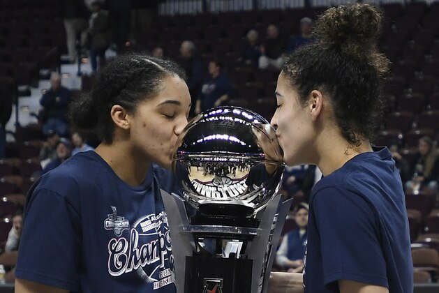 Connecticut's Gabby Williams and Kia Nurse, right, kiss the American Athletic Conference championship trophy after an NCAA college basketball game against South Florida in the final of the conference's women's tournament, Tuesday, March 6, 2018, in Uncasville, Conn. (AP Photo/Jessica Hill)