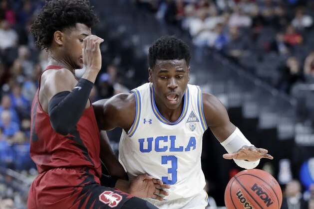 Stanford's Daejon Davis, left, covers a drive from UCLA's Aaron Holiday during the first half of an NCAA college basketball game in the quarterfinals of the Pac-12 tournament Thursday, March 8, 2018, in Las Vegas. (AP Photo/Isaac Brekken)