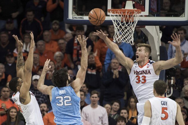 FILE - In this Jan. 6, 2018, file photo, Virginia's Jack Salt (33), Isaiah Wilkins, left, and Kyle Guy contest a shot by North Carolina's Luke Maye (32) during first half of an NCAA college basketball game in Charlottesville, Va. The Cavaliers lead the nation in scoring defense, allowing 52.7 points per game. (AP Photo/ Lee Luther Jr., File)