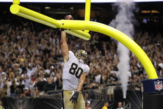 New Orleans Saints tight end Jimmy Graham (80) slam dunks over the goalpost after scoring on a touchdown reception in the second half of an NFL football game against the Arizona Cardinals in New Orleans, Sunday, Sept. 22, 2013. (AP Photo/Bill Haber)