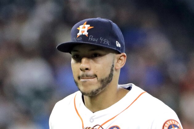 Houston Astros shortstop Carlos Correa wears messages on his cap for those affected by disasters in Mexico and Puerto Rico during the second inning of a baseball game Saturday, Sept. 23, 2017, in Houston. (AP Photo/David J. Phillip)