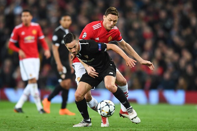 MANCHESTER, ENGLAND - MARCH 13:  Pablo Sarabia of Sevilla holds off Nemanja Matic of Manchester United during the UEFA Champions League Round of 16 Second Leg match between Manchester United and Sevilla FC at Old Trafford on March 13, 2018 in Manchester, United Kingdom.  (Photo by Michael Regan/Getty Images)