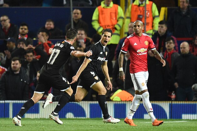 Sevilla's French forward Wissam Ben Yedder (C) celebrates with Sevilla's Spanish midfielder Pablo Sarabia after scoring during a last 16 second leg UEFA Champions League football match between Manchester United and Sevilla at Old Trafford in Manchester, northwest England on March 13, 2018. / AFP PHOTO / Oli SCARFF        (Photo credit should read OLI SCARFF/AFP/Getty Images)